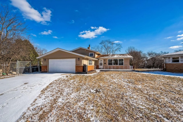 ranch-style house featuring a garage and covered porch