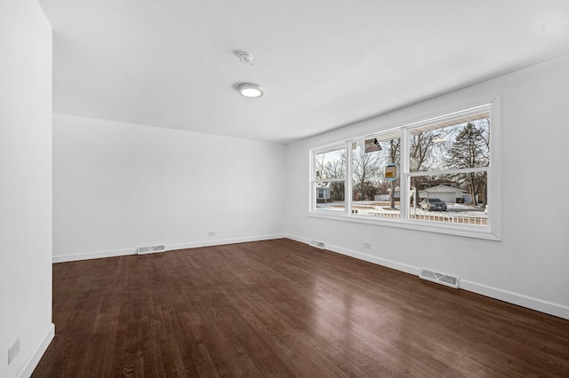 unfurnished room featuring dark hardwood / wood-style flooring