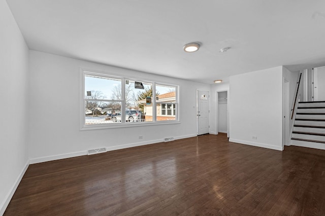 unfurnished living room with dark wood-type flooring