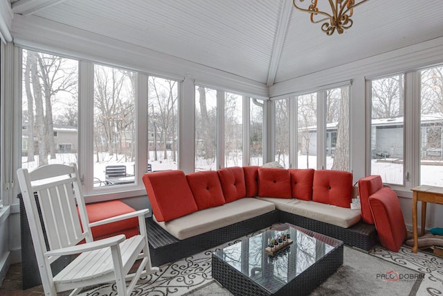 sunroom / solarium with a healthy amount of sunlight and lofted ceiling