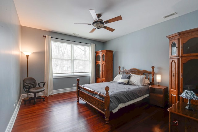 bedroom with visible vents, baseboards, and wood finished floors