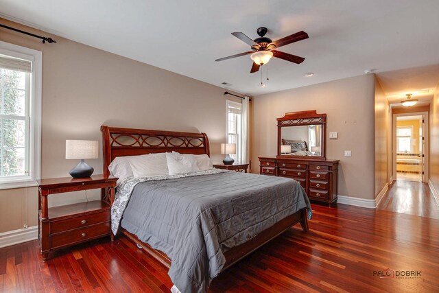 bedroom featuring visible vents, wood-type flooring, baseboards, and ceiling fan