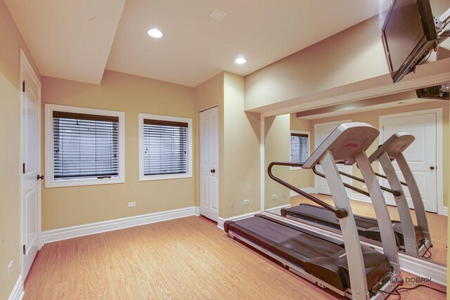 exercise room featuring recessed lighting, baseboards, and wood finished floors