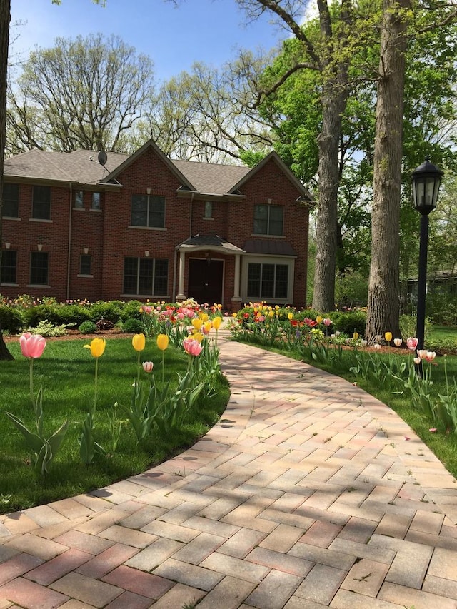 view of front of home featuring brick siding