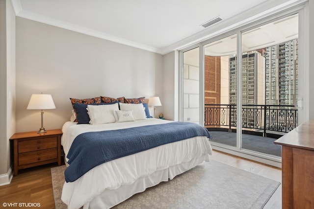 bedroom with access to outside, ornamental molding, floor to ceiling windows, and wood-type flooring