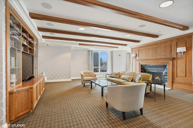 carpeted living room with beamed ceiling and a fireplace