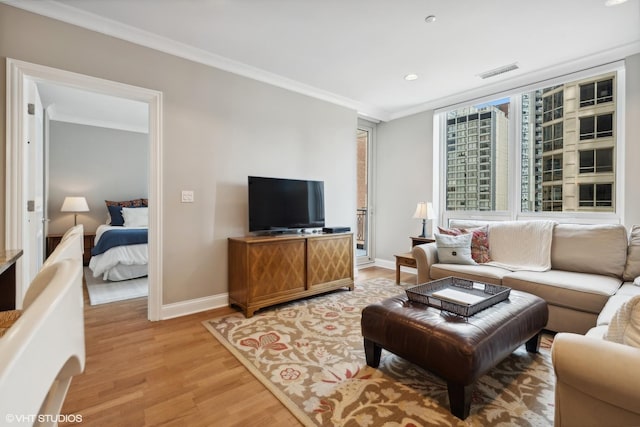 living room featuring crown molding and light wood-type flooring