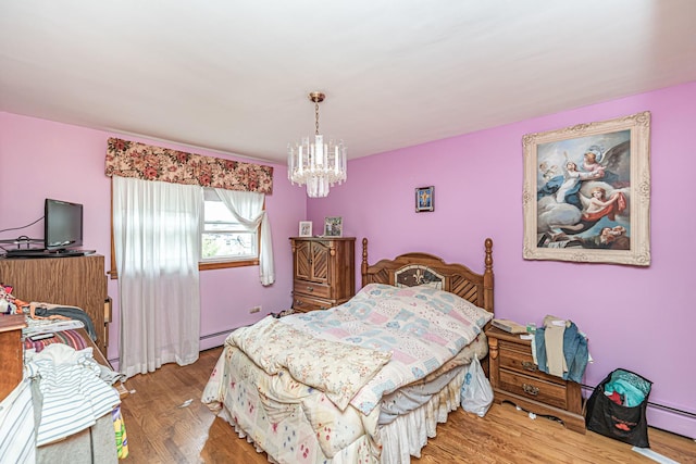 bedroom featuring wood-type flooring, a chandelier, and a baseboard radiator