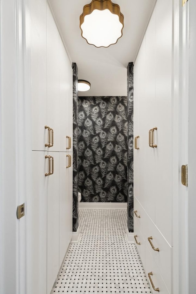 bathroom with wallpapered walls, a shower with curtain, and baseboards