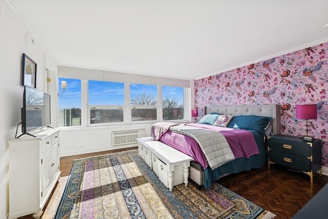 bedroom with a wall mounted air conditioner, baseboards, crown molding, and wallpapered walls