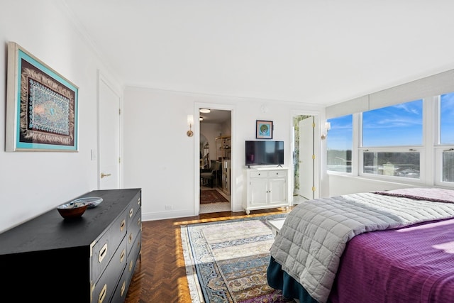 bedroom featuring baseboards and crown molding