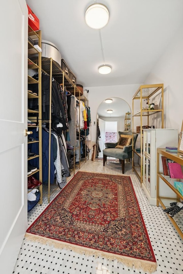 spacious closet with arched walkways