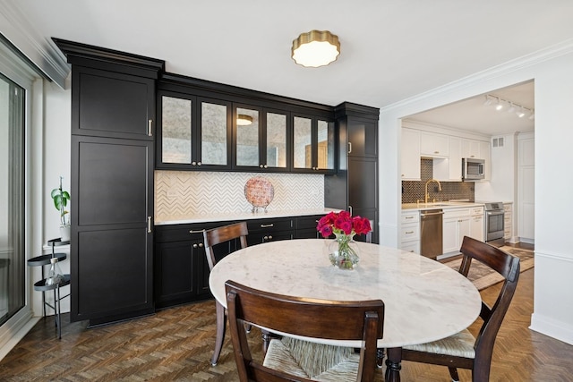 dining space with ornamental molding