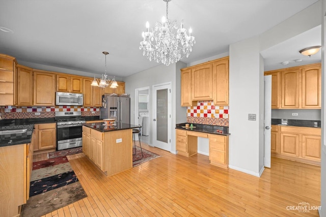 kitchen featuring built in desk, light wood-style flooring, stainless steel appliances, and open shelves