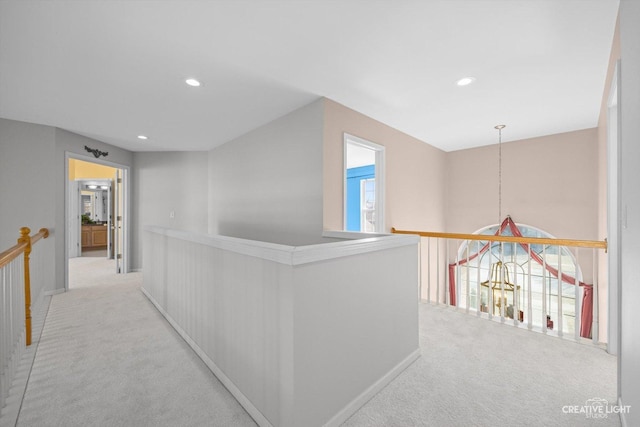 hallway featuring an upstairs landing, recessed lighting, and carpet floors