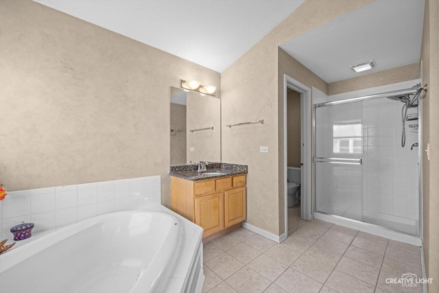 bathroom featuring tile patterned floors, a stall shower, toilet, and a garden tub