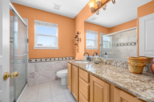 bathroom with plenty of natural light, vanity, and a shower stall