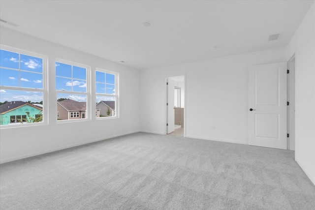 unfurnished room featuring light colored carpet