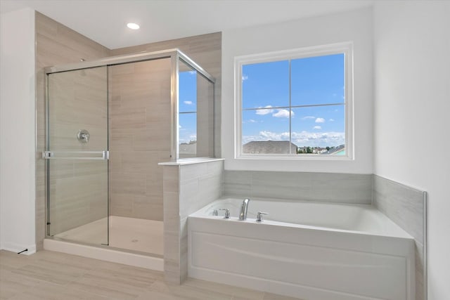 bathroom with shower with separate bathtub