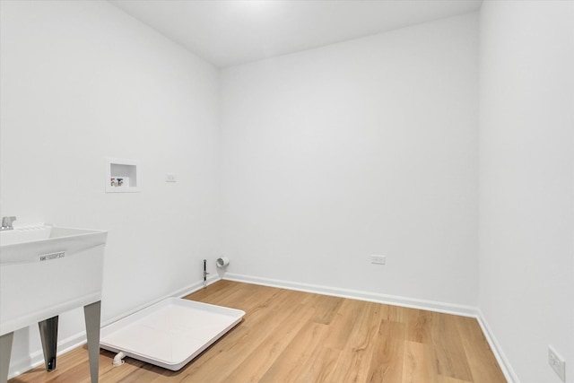 laundry room with wood-type flooring, sink, and hookup for a washing machine