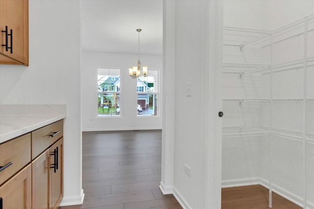 interior space featuring dark wood-type flooring and a notable chandelier