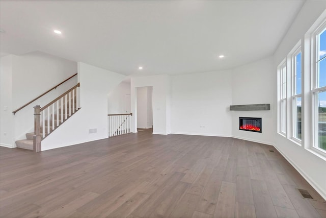 unfurnished living room featuring hardwood / wood-style flooring