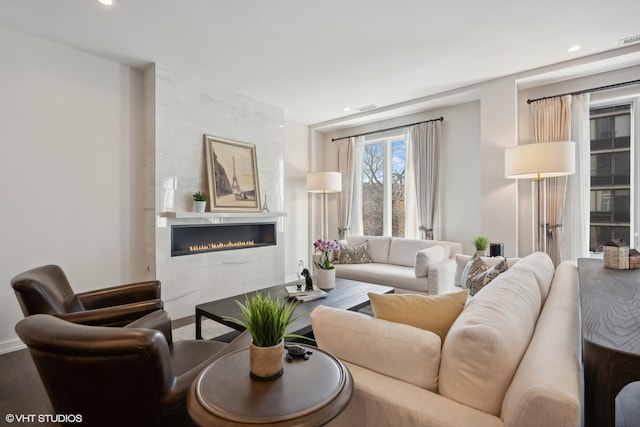 living room featuring hardwood / wood-style flooring and a fireplace