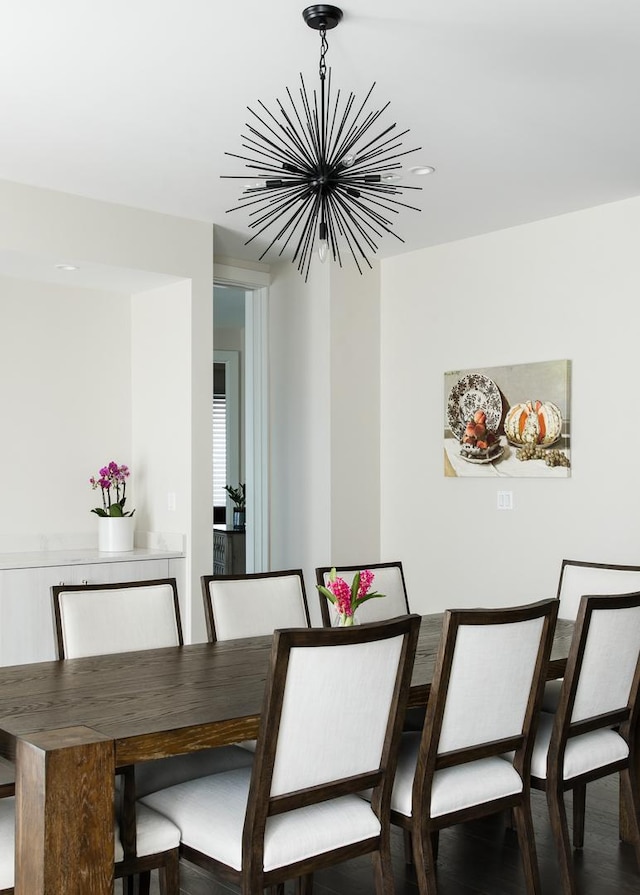 dining room with a notable chandelier and dark wood-type flooring