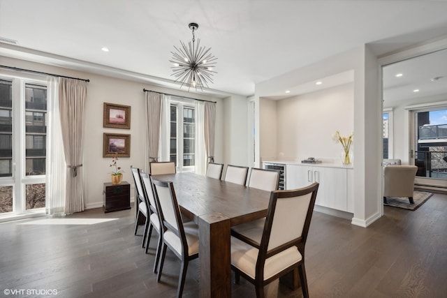 dining area with wine cooler, dark wood-type flooring, and a chandelier