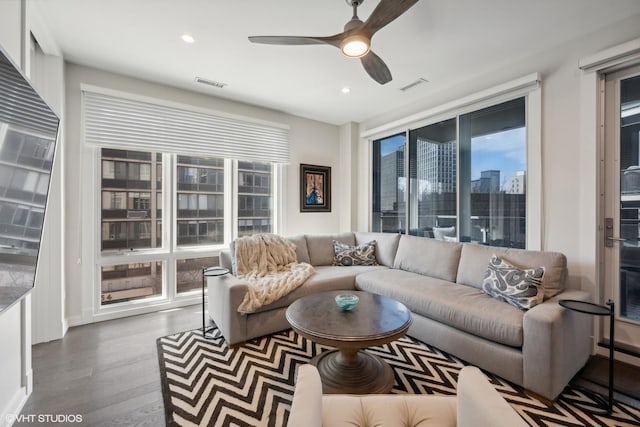 living room featuring dark hardwood / wood-style floors and ceiling fan