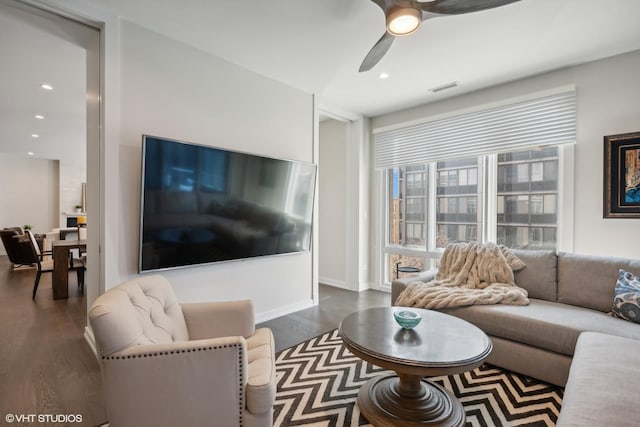 living room featuring dark hardwood / wood-style floors and ceiling fan