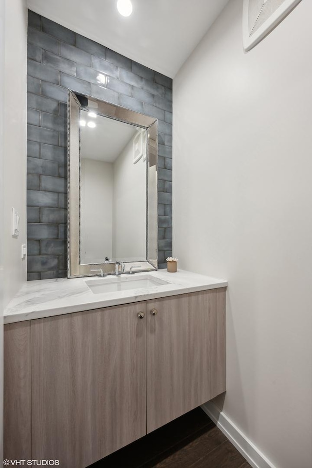 bathroom with hardwood / wood-style flooring, vanity, and a wall mounted AC