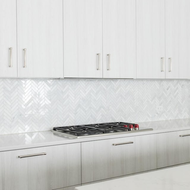 kitchen featuring stainless steel gas cooktop and white cabinets