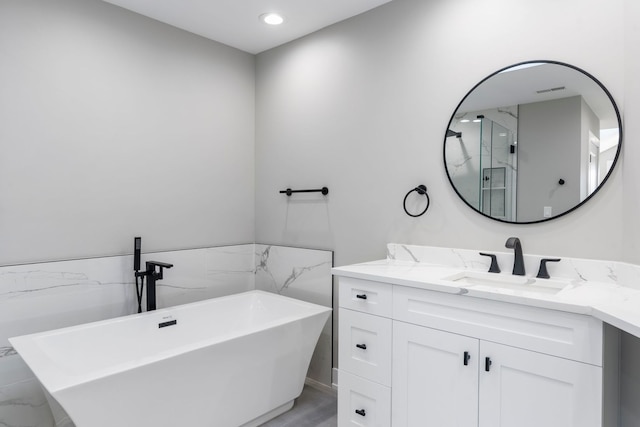 bathroom featuring vanity and separate shower and tub