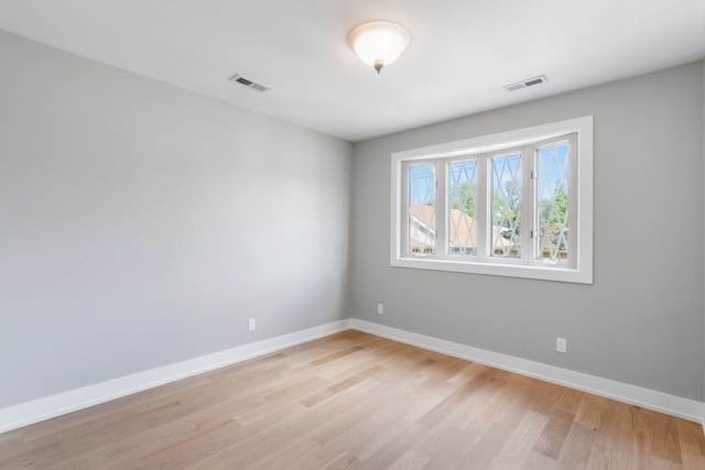 empty room with light hardwood / wood-style flooring