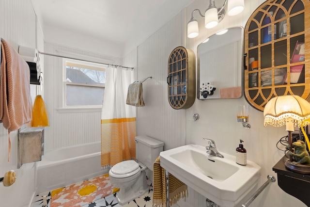 full bath with shower / bath combo, a sink, toilet, and tile patterned floors