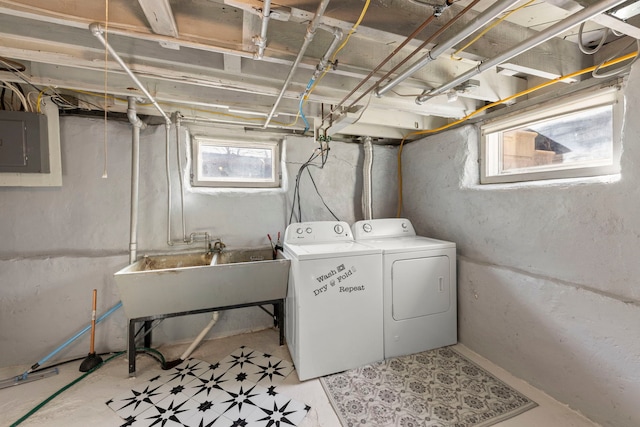 laundry area featuring washer and dryer, laundry area, electric panel, and a sink