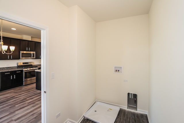 washroom featuring dark hardwood / wood-style flooring, hookup for a washing machine, and a notable chandelier