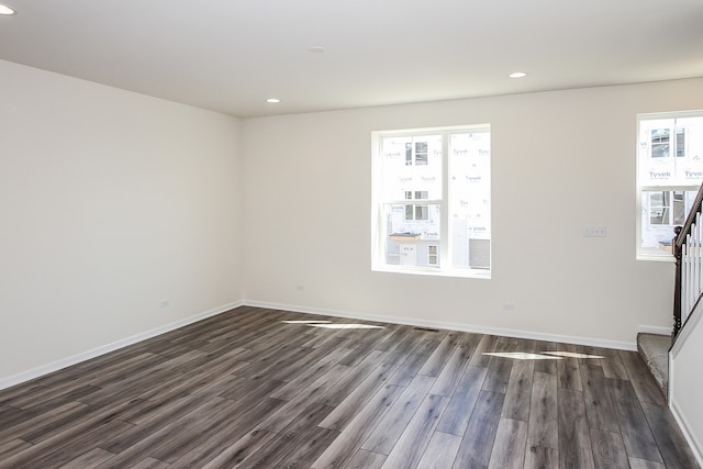 spare room with dark hardwood / wood-style flooring