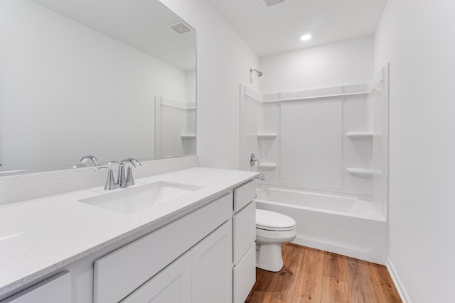 full bathroom featuring vanity, wood-type flooring, shower / tub combination, and toilet