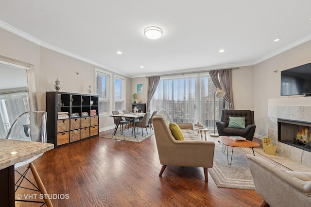 living room with dark wood-type flooring, a fireplace, and crown molding