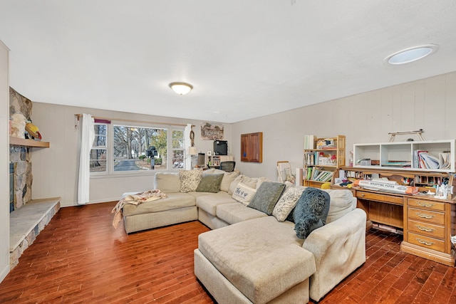 living room featuring dark hardwood / wood-style flooring and a fireplace