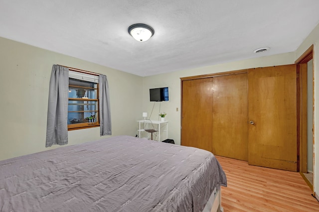 bedroom with hardwood / wood-style flooring and a closet