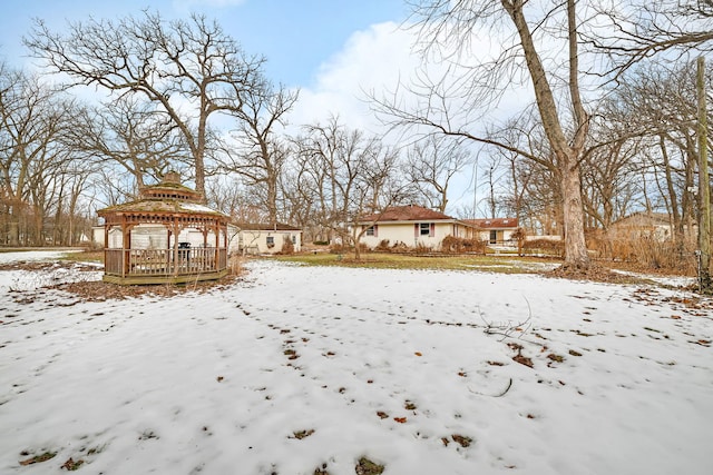 snowy yard featuring a gazebo