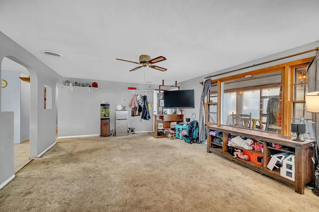 living room featuring carpet floors and ceiling fan