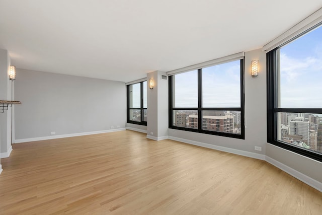 unfurnished living room featuring light hardwood / wood-style flooring and a wealth of natural light