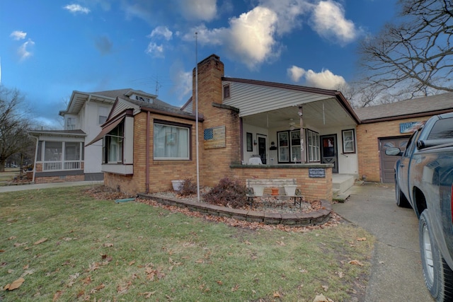 back of house featuring a porch, a yard, and ceiling fan