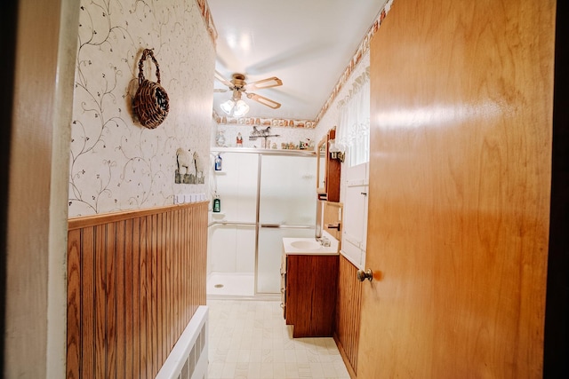 bathroom with vanity, a shower, and ceiling fan