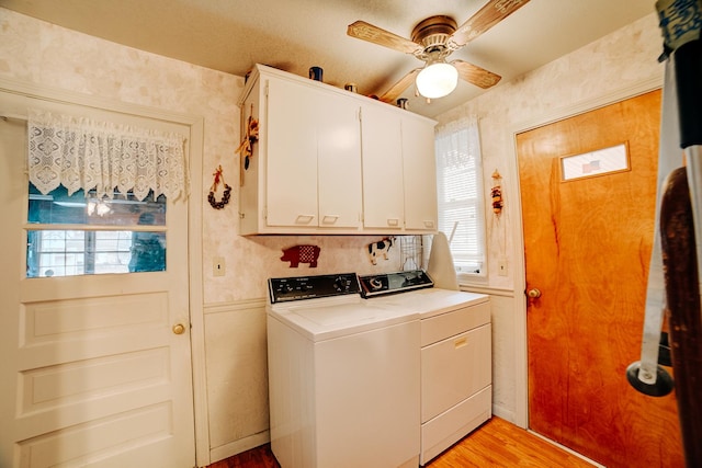 laundry room with cabinets, ceiling fan, washer and dryer, and light wood-type flooring