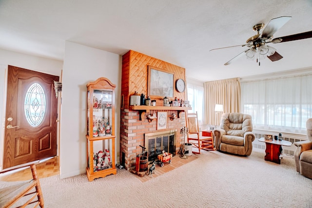 living room with ceiling fan, carpet, a healthy amount of sunlight, and a fireplace